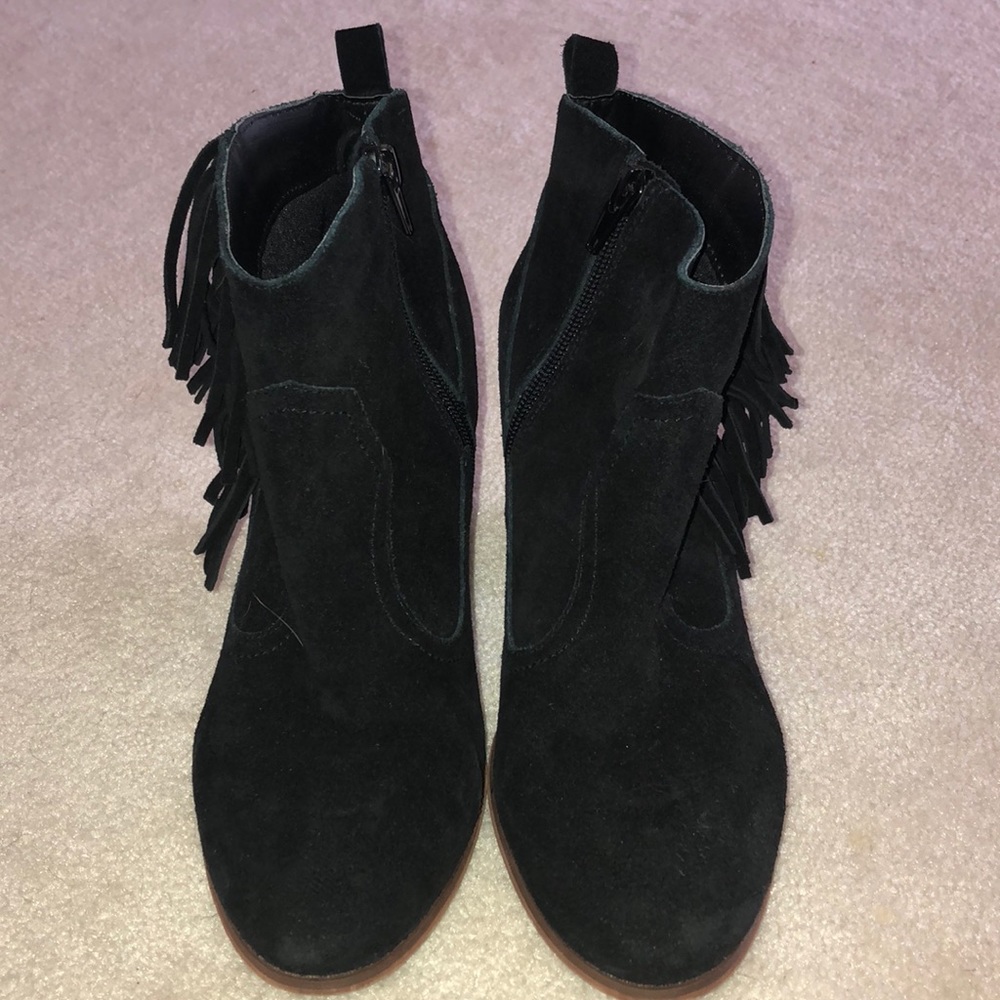 Restricted black suede fringe booties.
